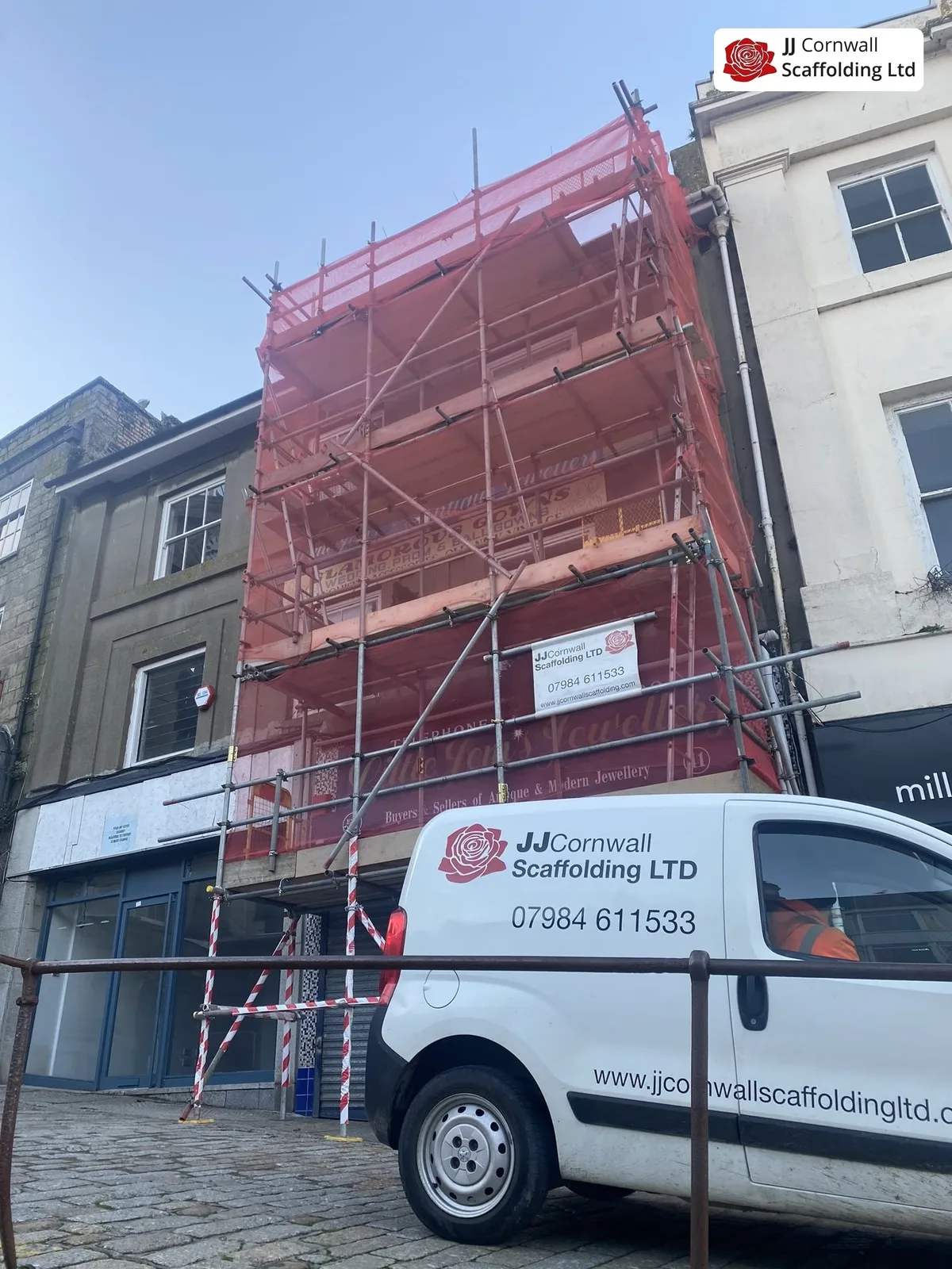 JJ Cornwall Scaffolding: white branded van at a red netted town centre job