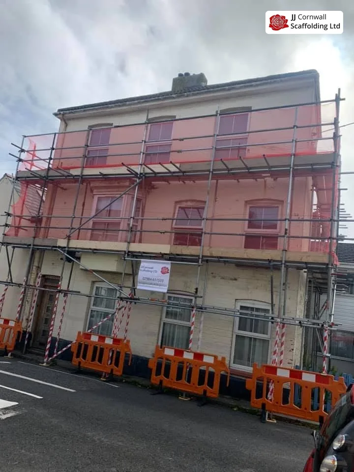 Commercial scaffolding in Cornwall: three storey terrace red netting with pedestrian barriers