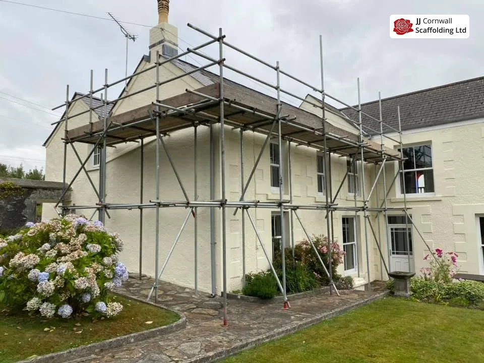 Domestic scaffolding in Cornwall: cream rendered house two lift scaffold over hydrangeas