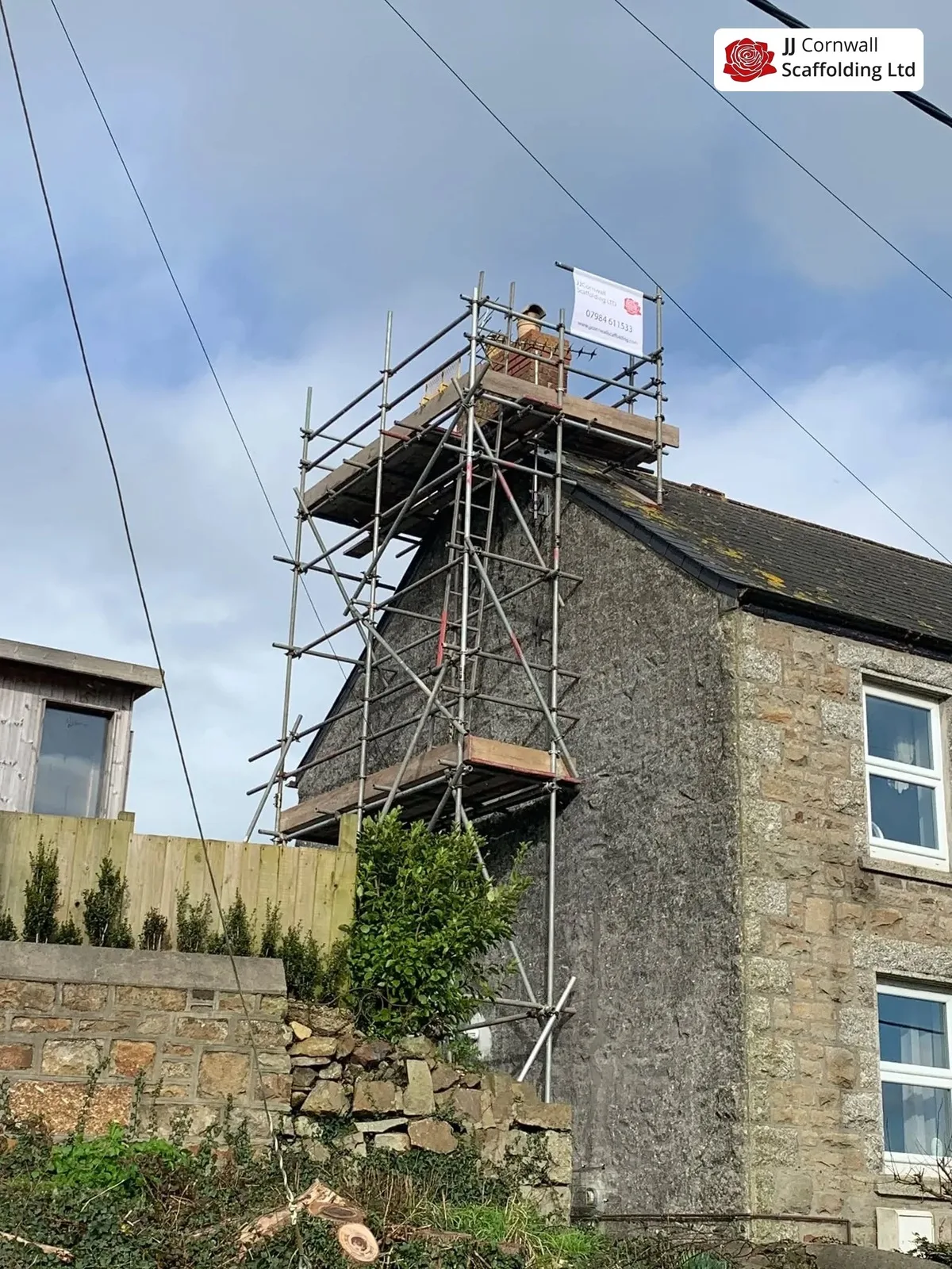 Bracketed chimney access on a narrow street in Penzance