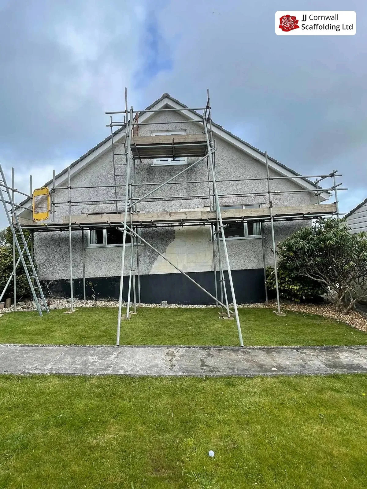 Domestic scaffolding in Cornwall: rendered gable independent scaffold across the lawn