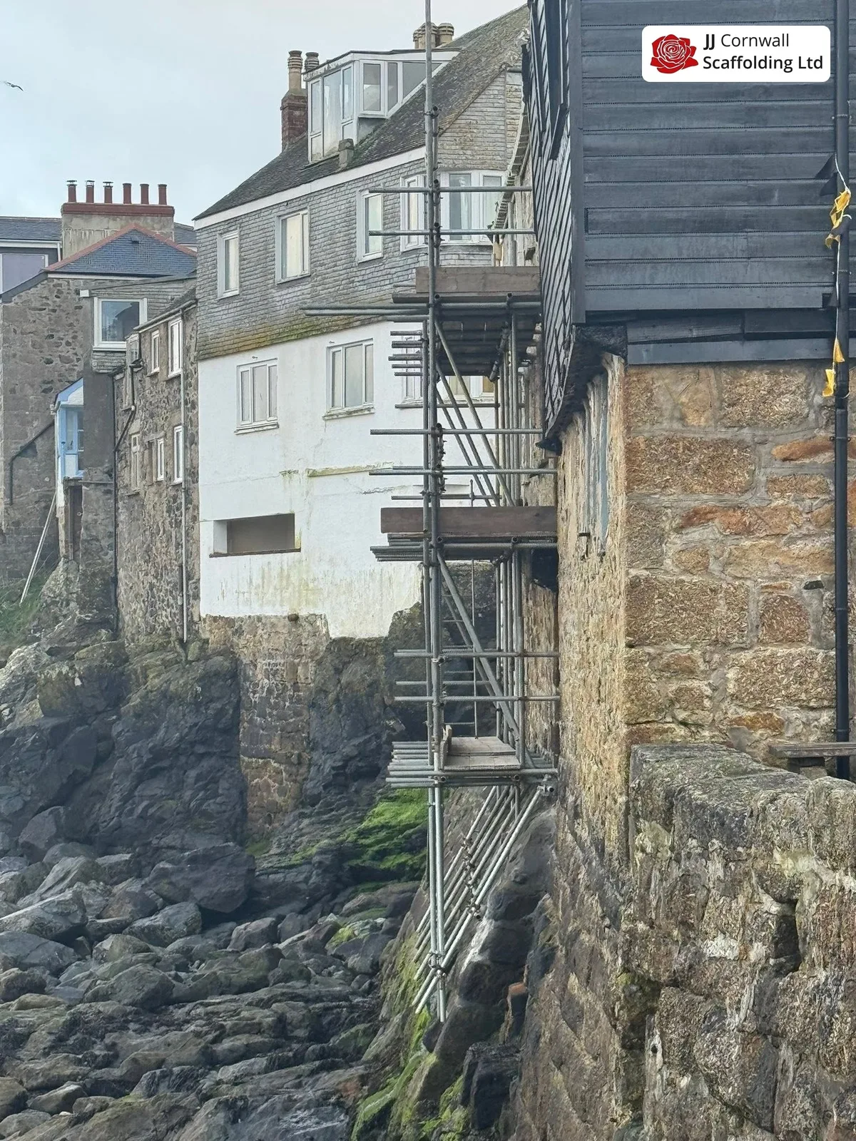 Scaffold on a weathered seaward elevation near Perranporth beach