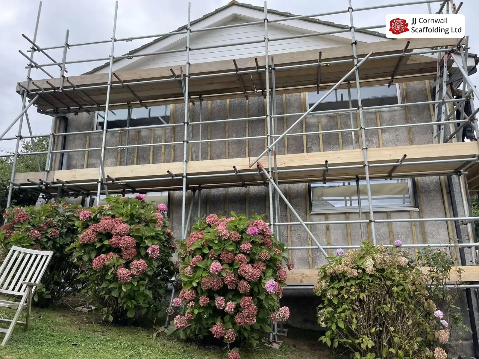 Domestic scaffolding in Cornwall: timber clad house two lift scaffold over hydrangeas