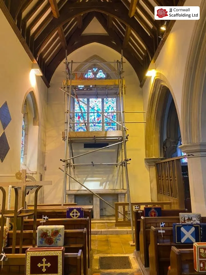 Heritage scaffolding in Cornwall: listed church internal birdcage scaffold to stained glass window under timber trusses