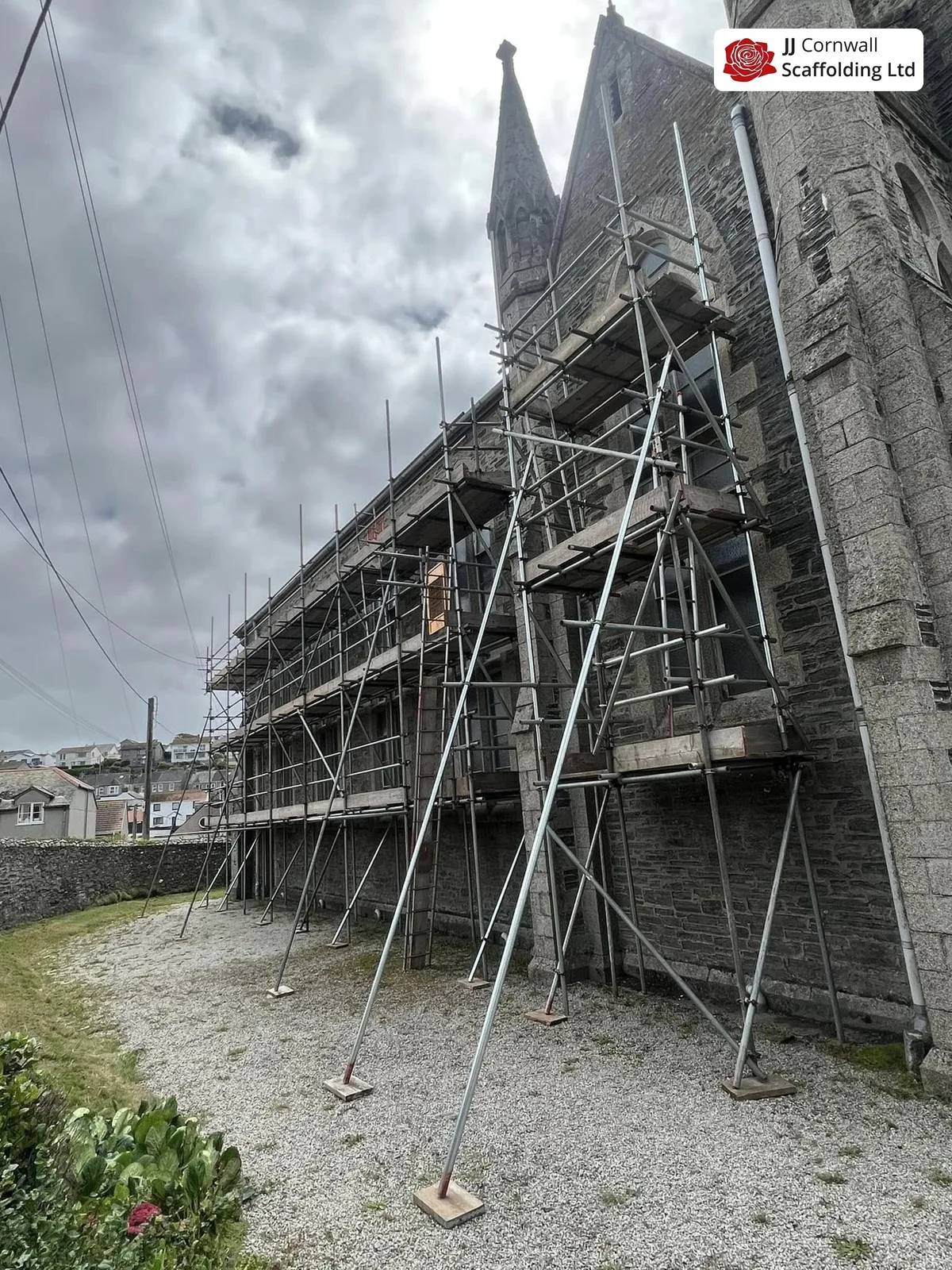 Heritage scaffolding in Cornwall: listed granite church with spire long run of independent scaffold