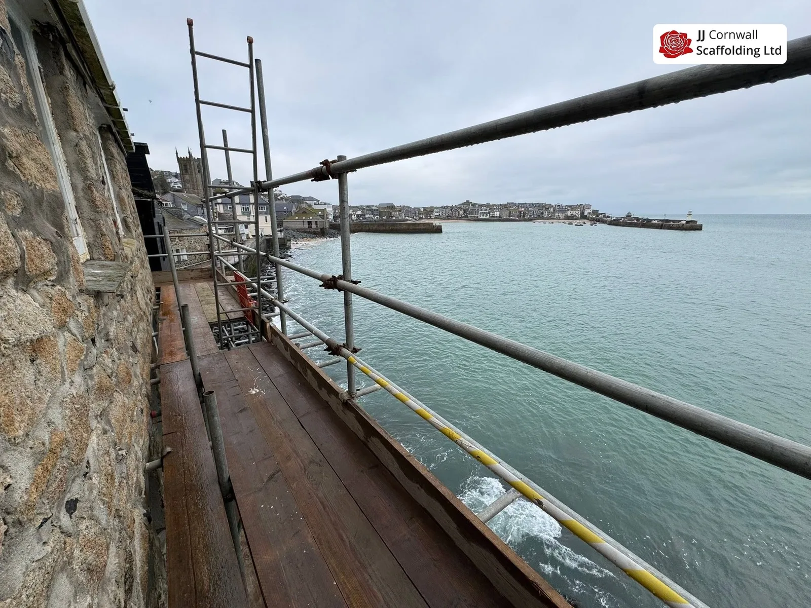 Scaffold hire in Cornwall: sea facing deck and guardrail with st ives harbour beyond